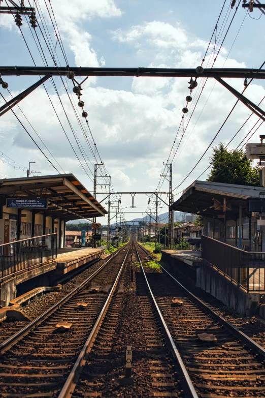 a view of train tracks on a sunny day