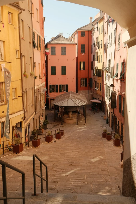 the alley is lined with many houses and apartment buildings