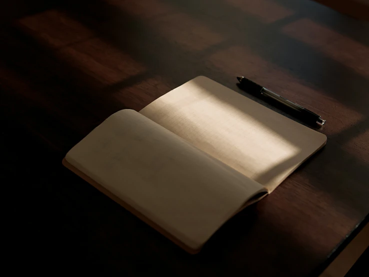 an open notebook sitting on top of a wooden table