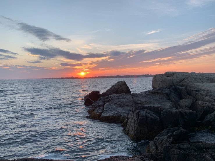 a sunset with a beautiful sky over the water