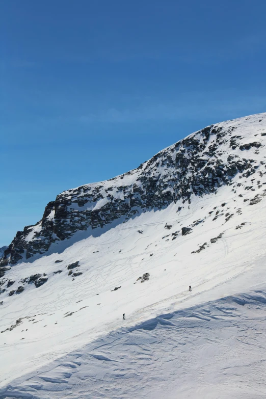 someone snowboards on the snow covered mountain side