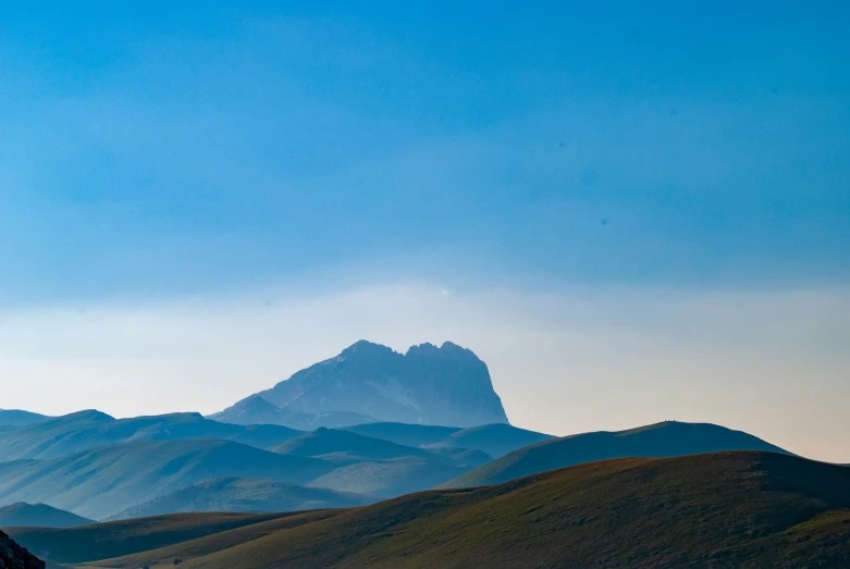 the mountains are rising in the background of the landscape