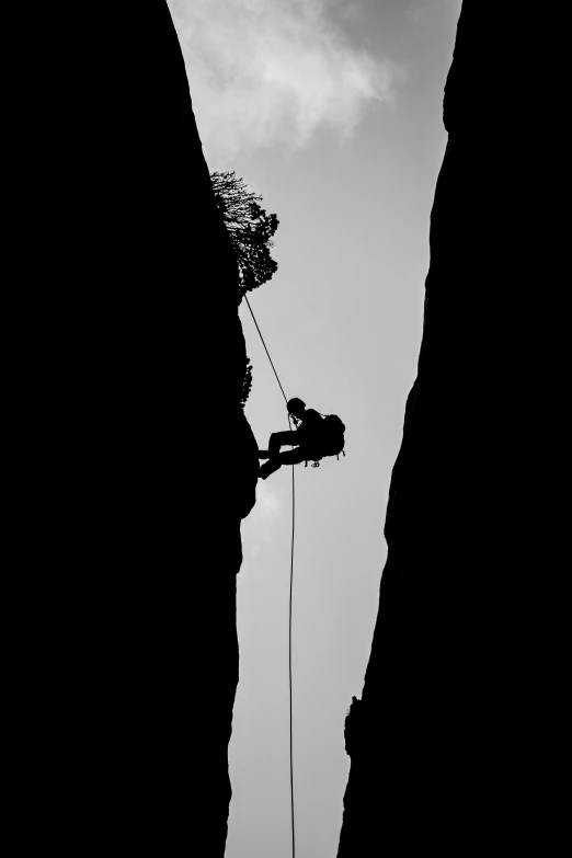 a man in the air trying to climb a rock