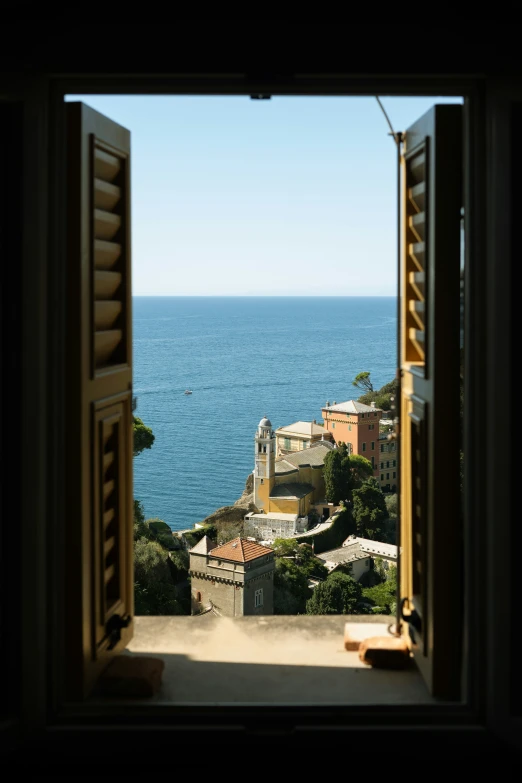 a view of the ocean from an open door