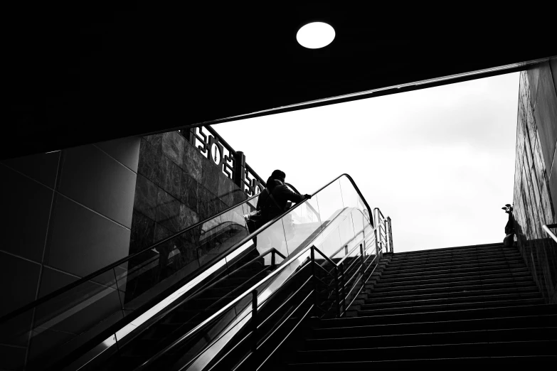 man in a subway station on the escalator