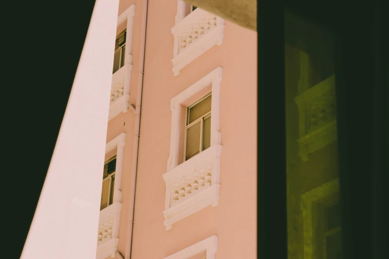 a building with white details sits behind a window