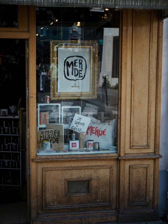 a wooden shop with signs on the window