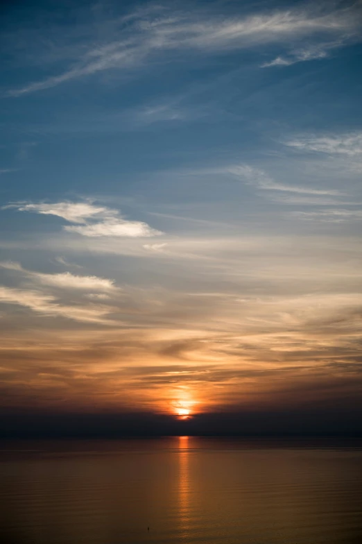 a view of the sun over the ocean during sunset