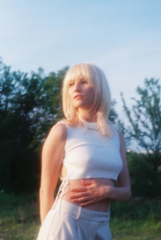 a woman in white shirt and shorts outside