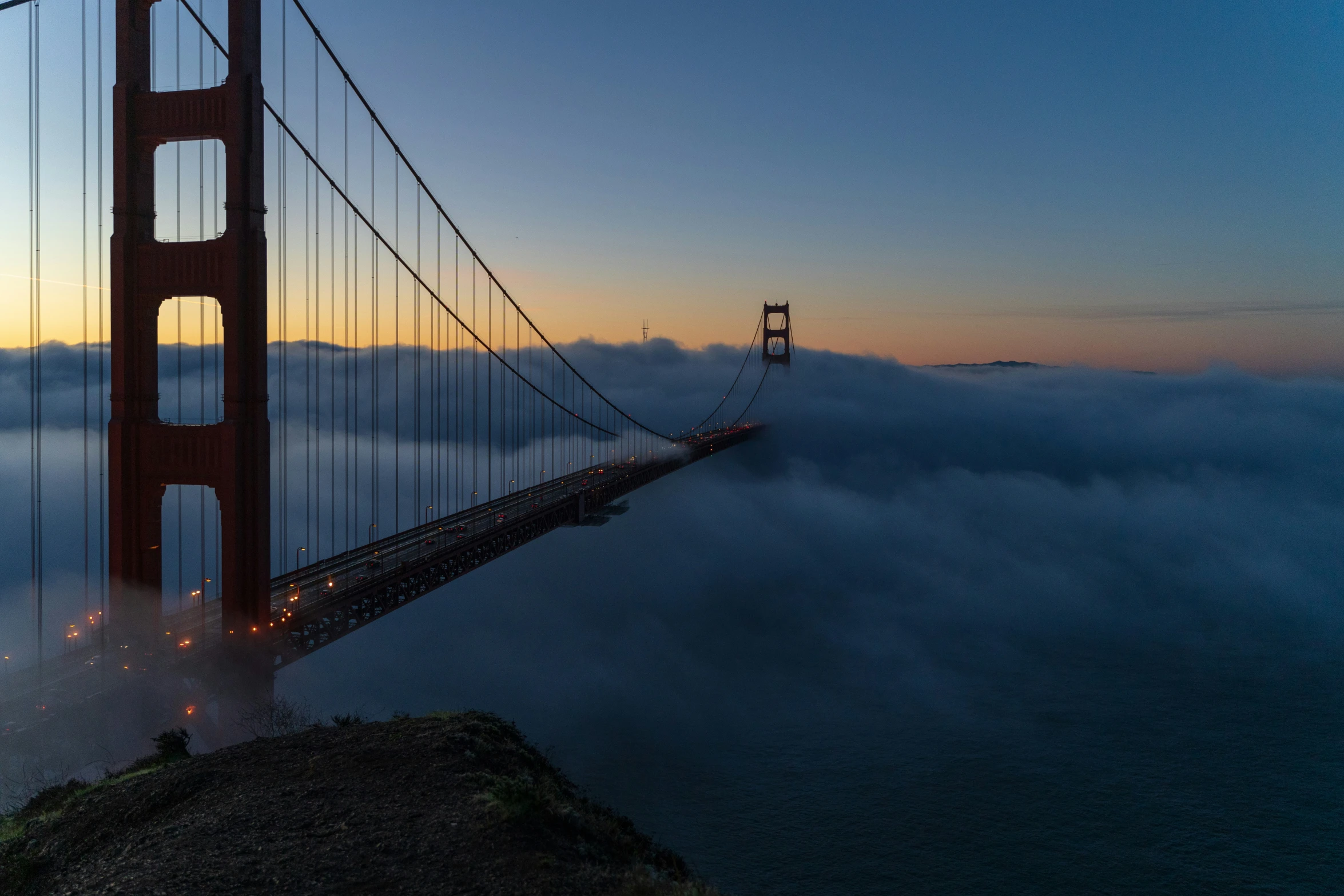 the golden gate bridge in the foggy skies