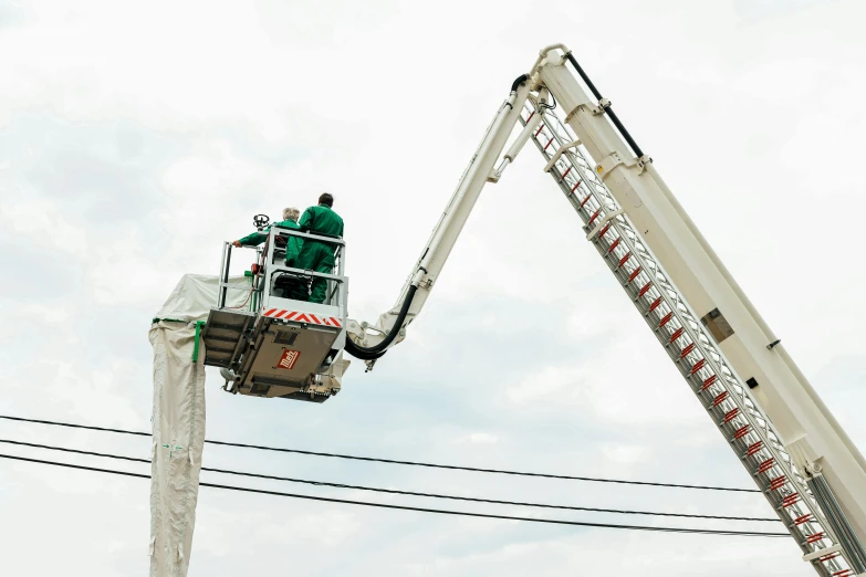 a man riding a giant crane up to the top of it