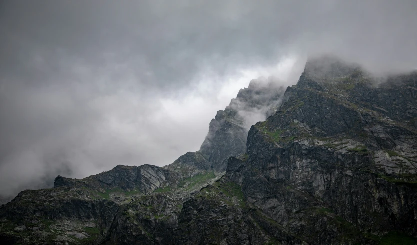 very tall mountain with mist coming off the top