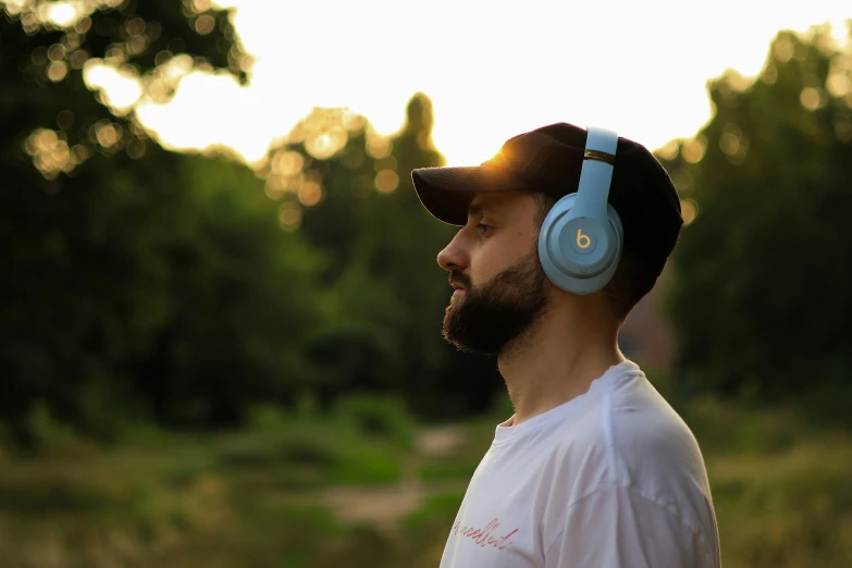 a man with a beard and blue earphones