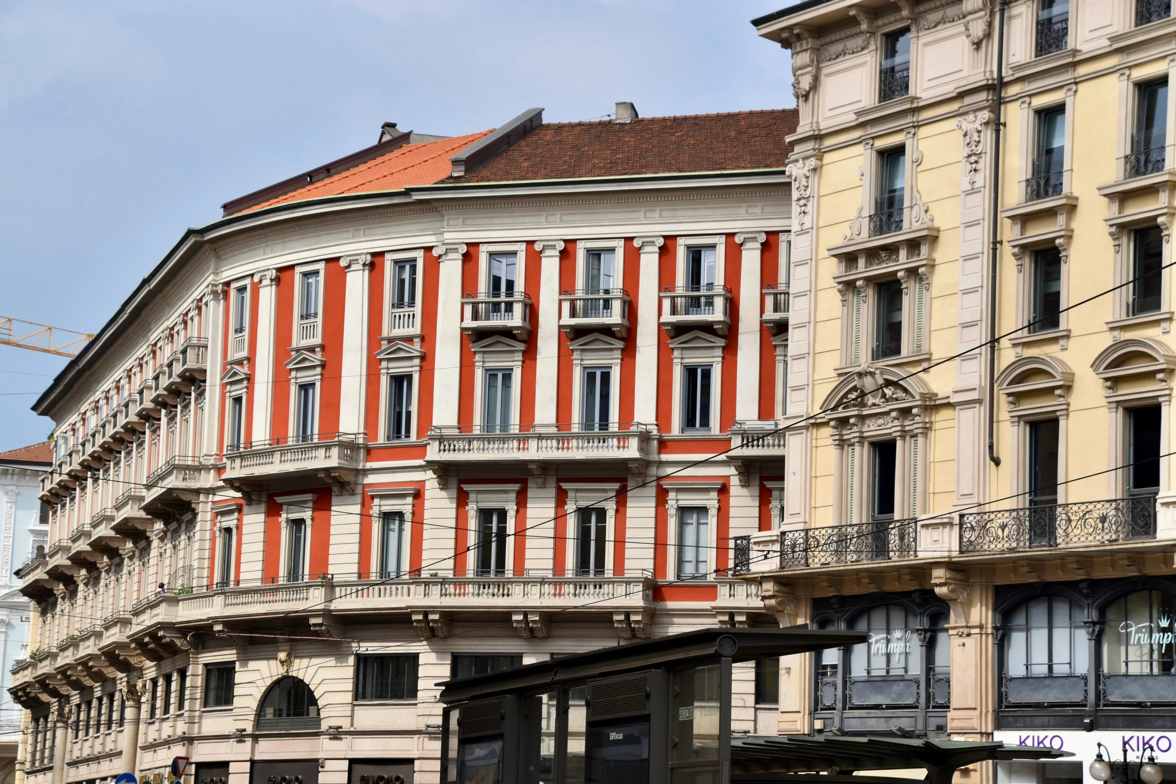 a brown and white building and buildings on street