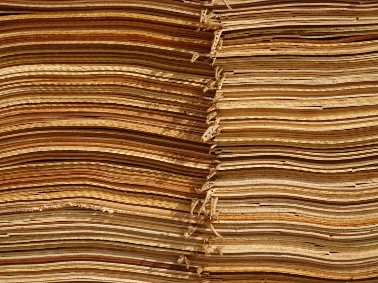 an old stack of wood grain is stacked high