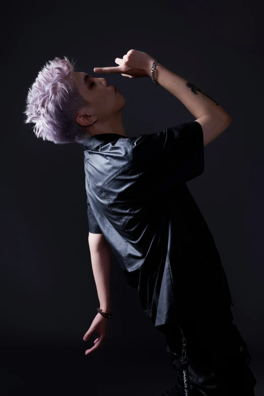 a woman with grey hair posing in a dark room