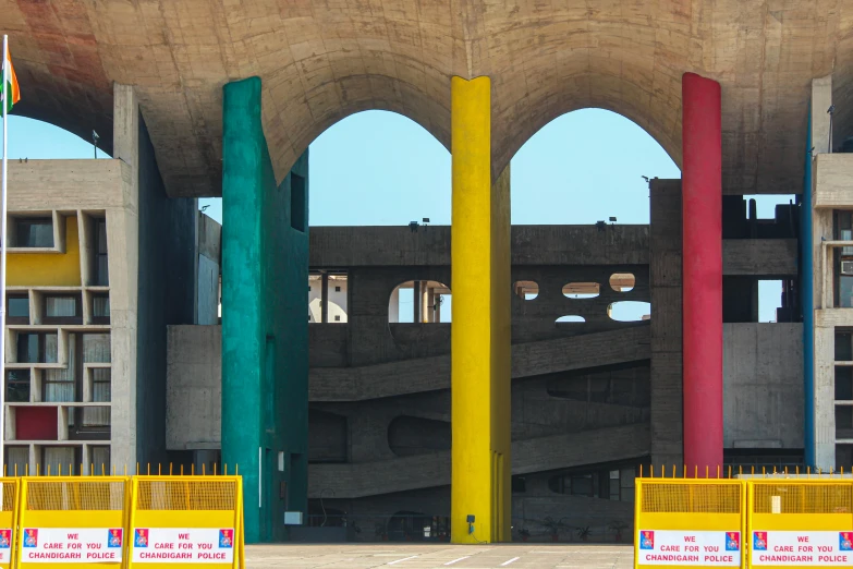 colorful columns in front of a building with concrete