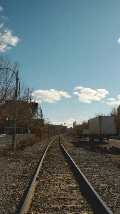 an empty railroad track is shown in front of a building