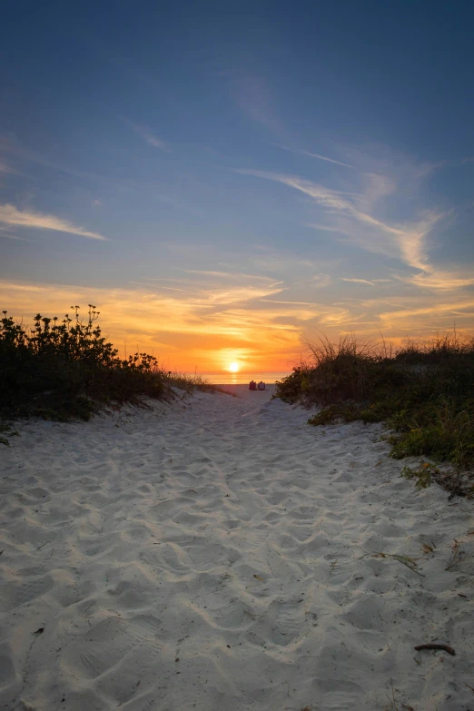 the beach is clear as the sun sets