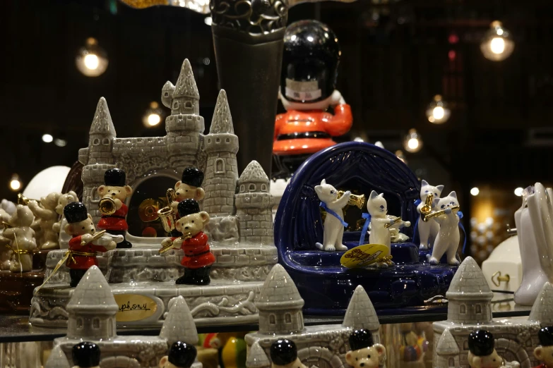 many figurines are in a display and there is a castle in the background