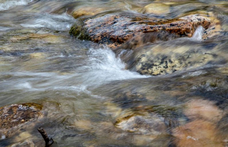 a stream of water that is flowing down rocks