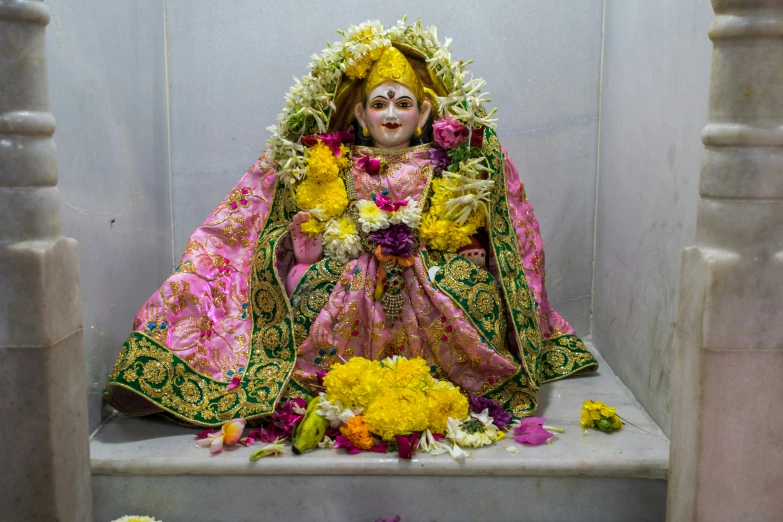 the statue sits in a niche next to a potted plant