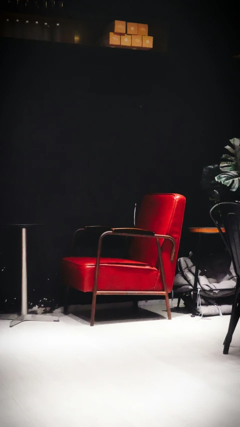 red chairs are in front of a white lamp