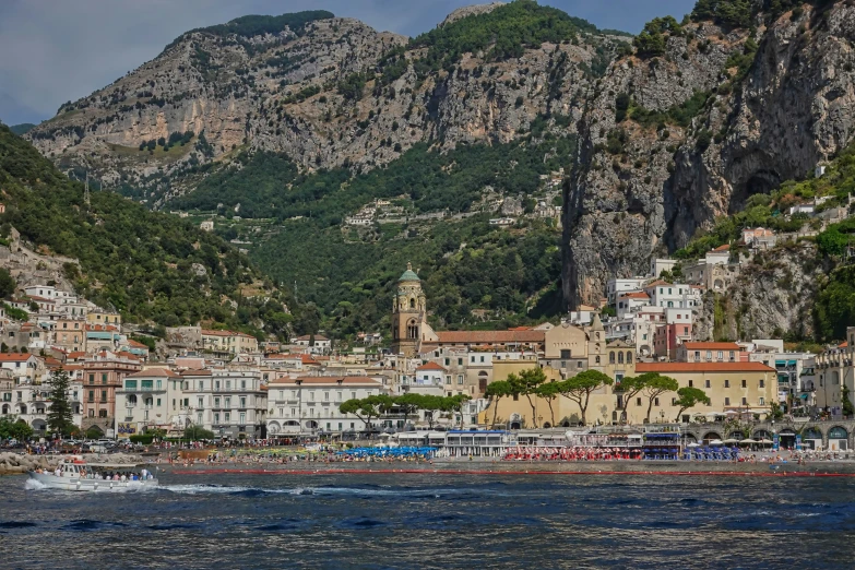 a mountain town surrounded by trees and boats