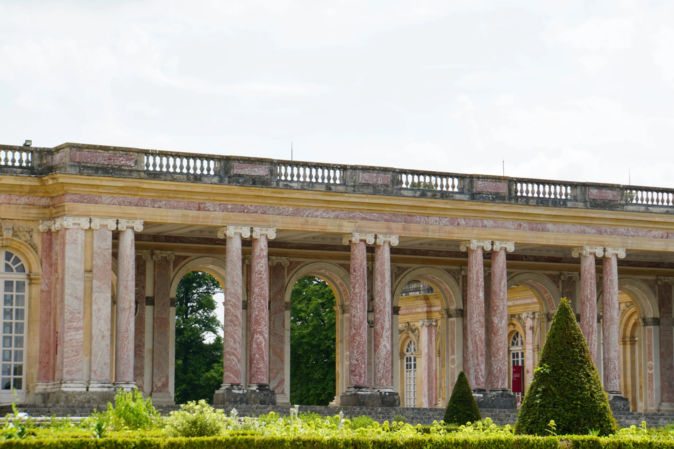 a building with a few columns on top and three pillars in front