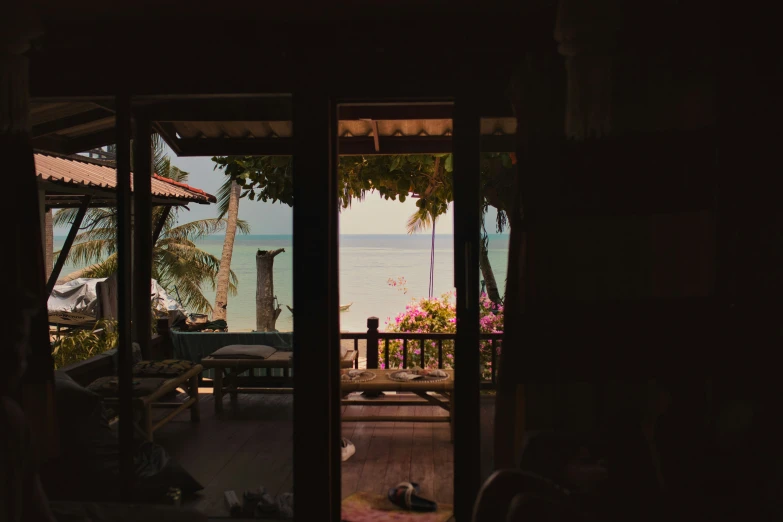 a view out of a door of the ocean