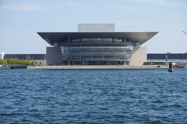 a large building is sitting out on a waterfront