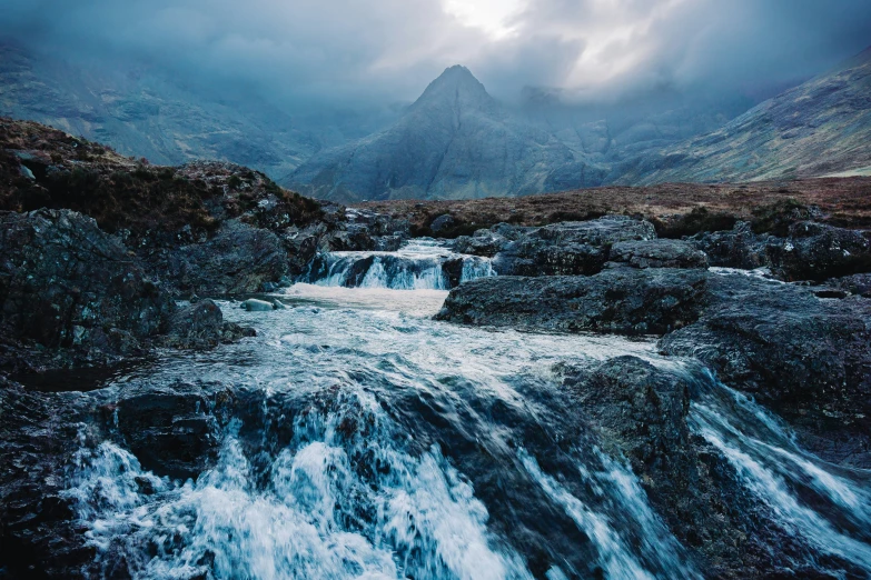 the stream is running down the mountains to reach the sky