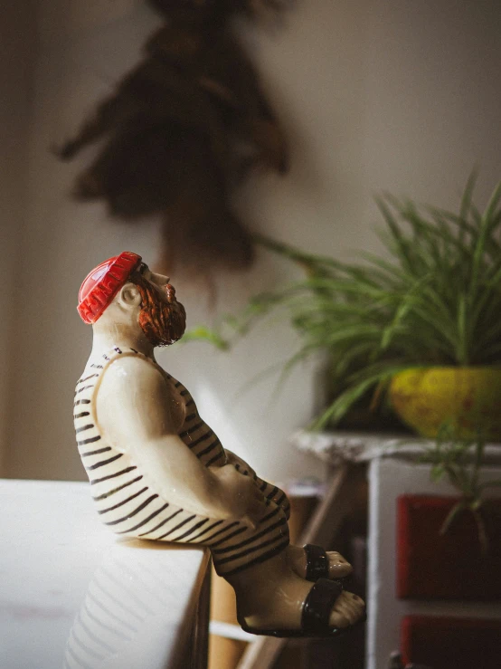 a wooden statue with a striped shirt on