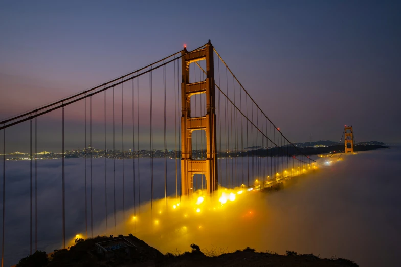 the golden gate bridge is illuminated at night