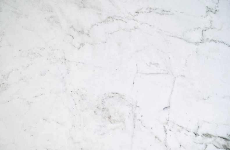 the texture of white marble is shown with a light gray stain