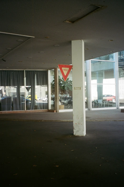 a red triangular sign sitting in the middle of a room