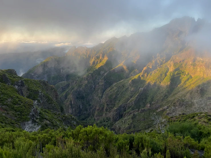 the fog moves over the tops of the mountains