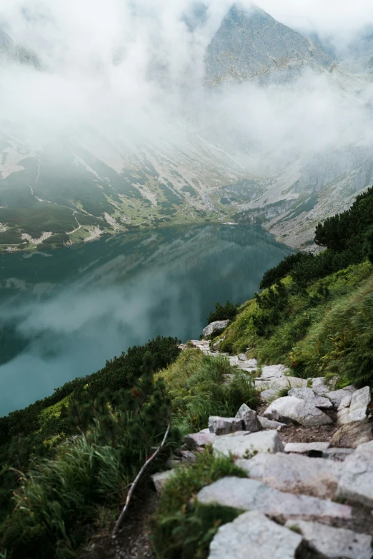 a grassy and rocky path on a mountain side