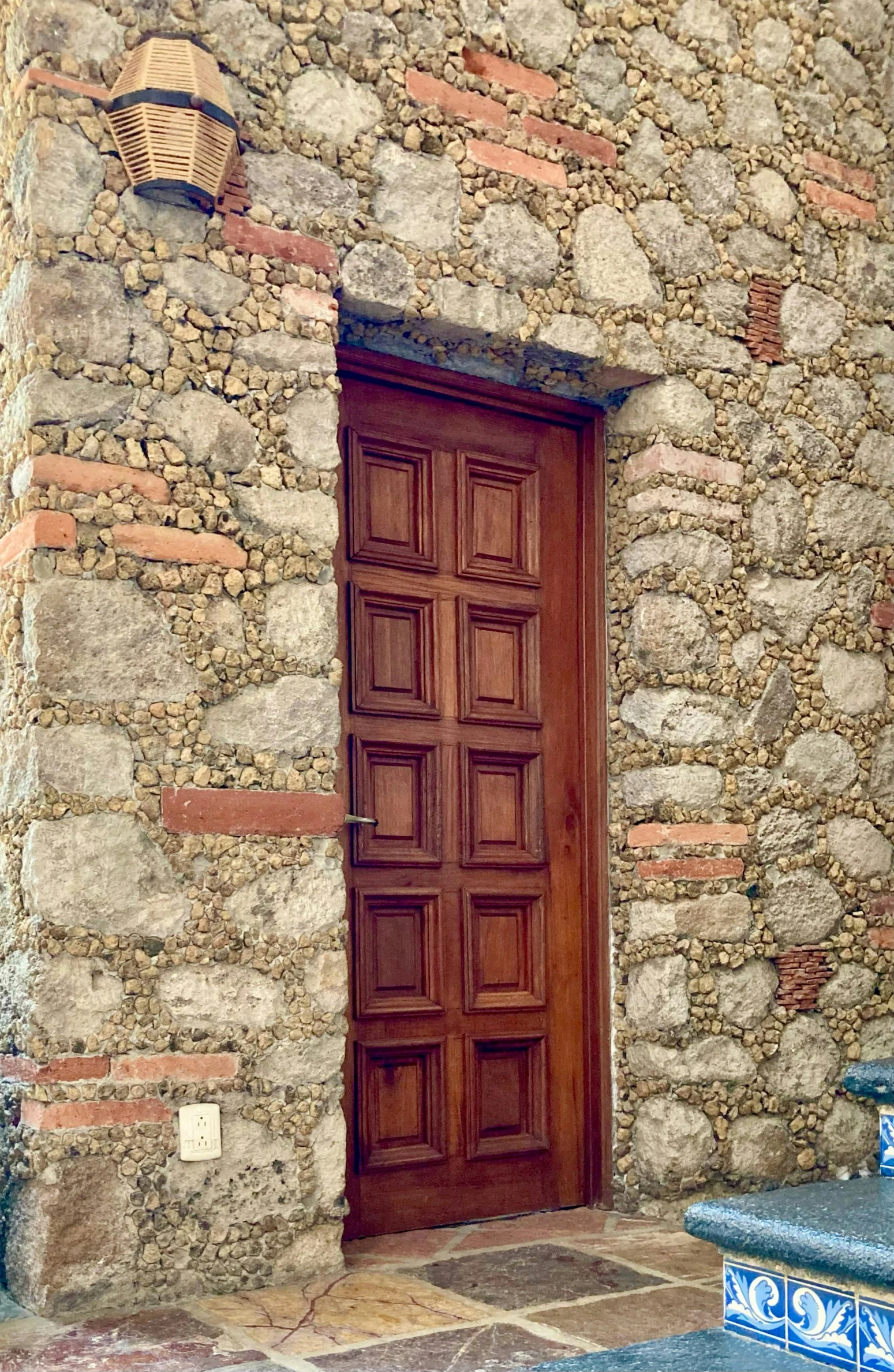 an old house has a bench next to it