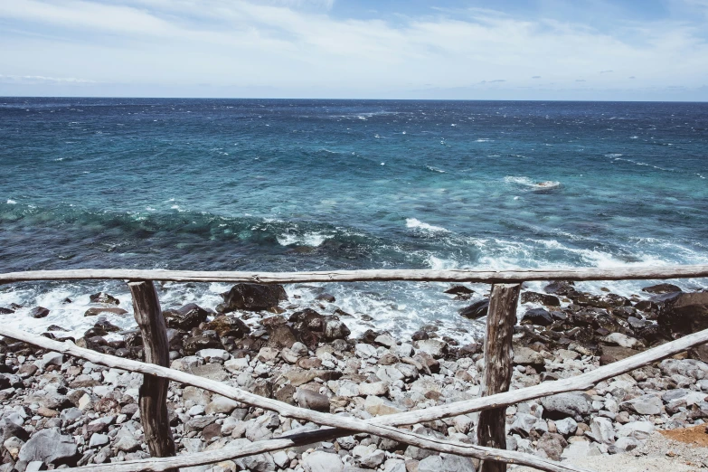 a woman is walking along the ocean shore