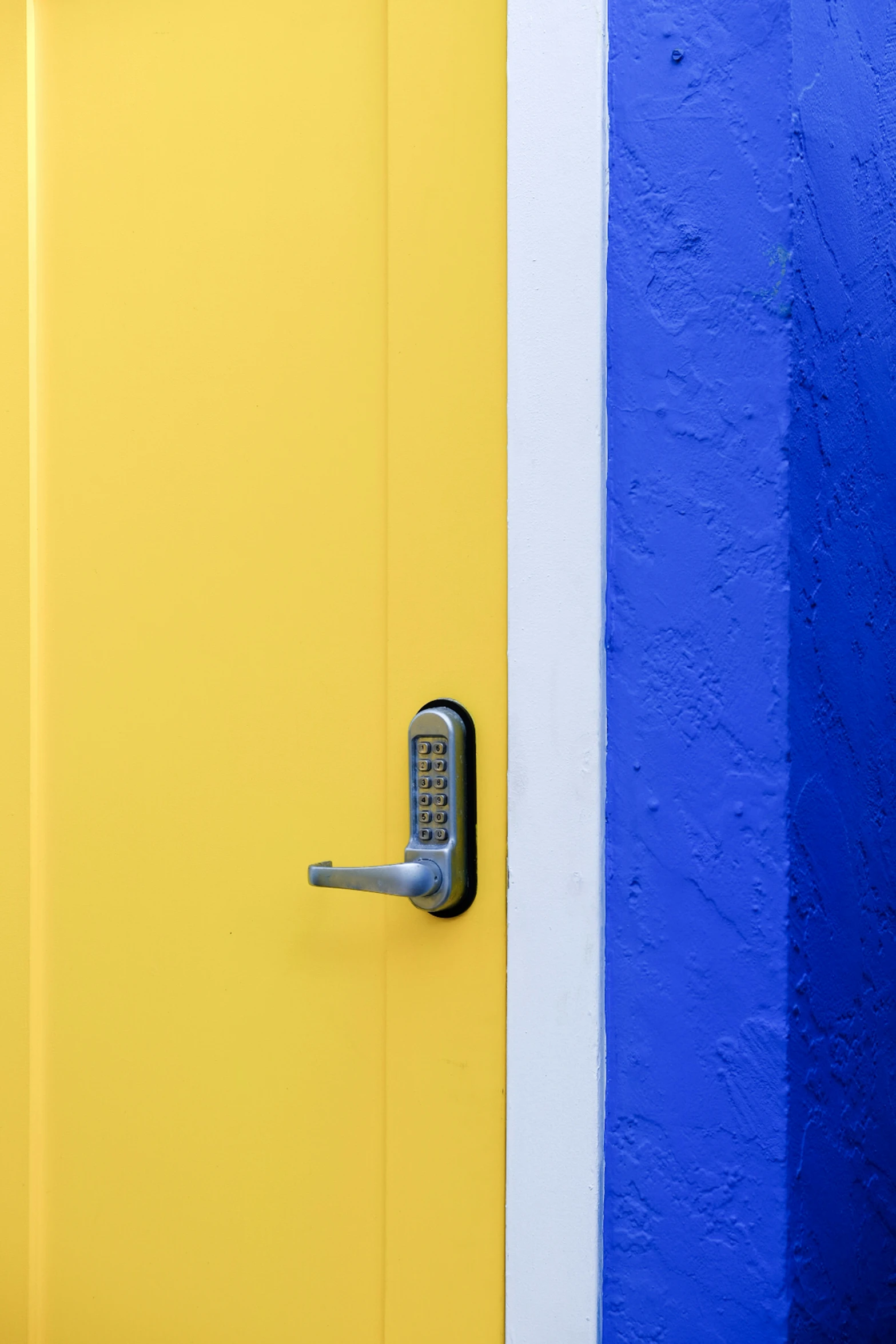 a close - up of the front door to a house with a blue and yellow wall