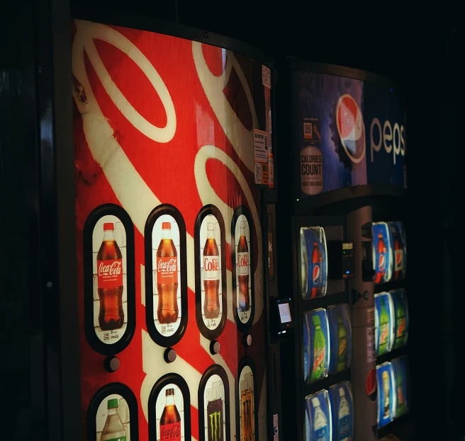 a vending machine has several pepsi bottles on it