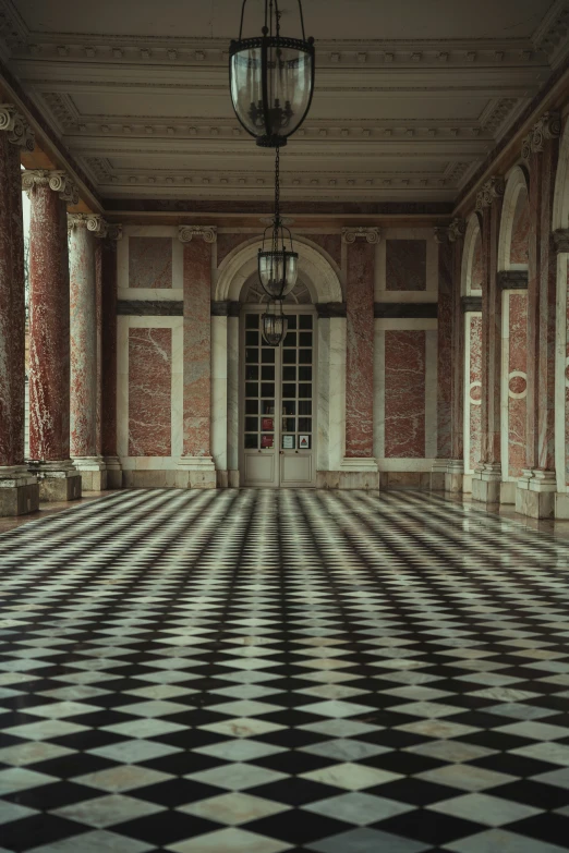 a hallway with a checkered floor and four lamps