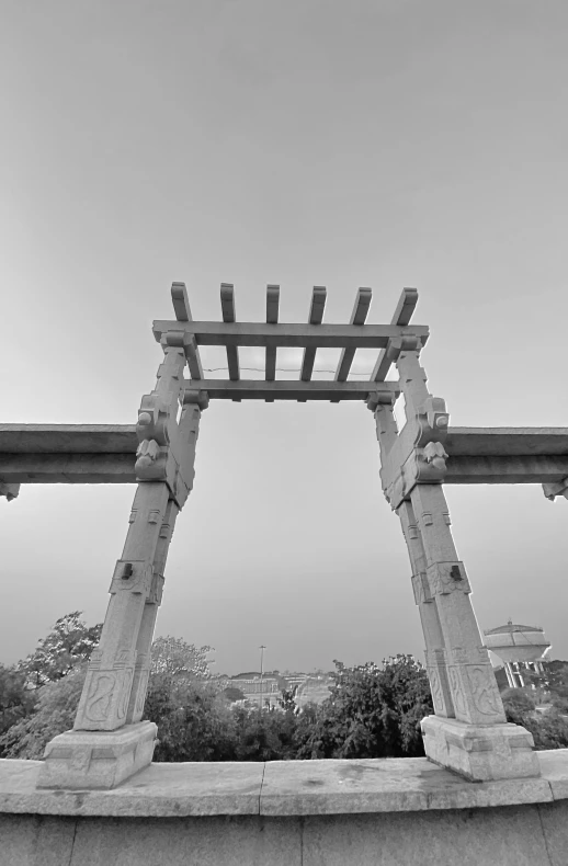 two carved wooden structures on top of a roof