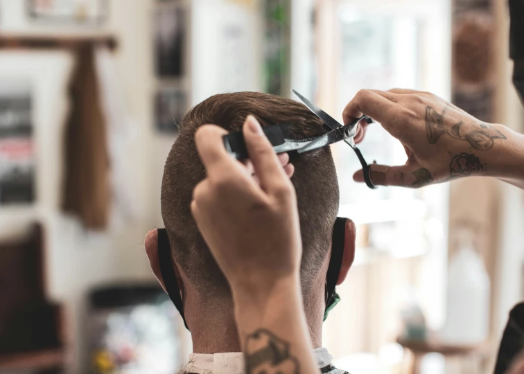 a barber  the hair of a client