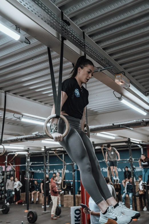 there is a woman doing gymnastics on the rings