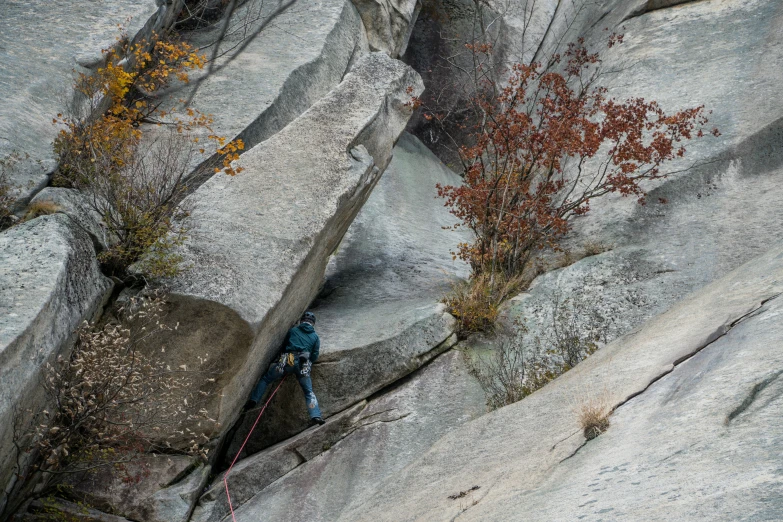 two people climbing up and down an icy mountain