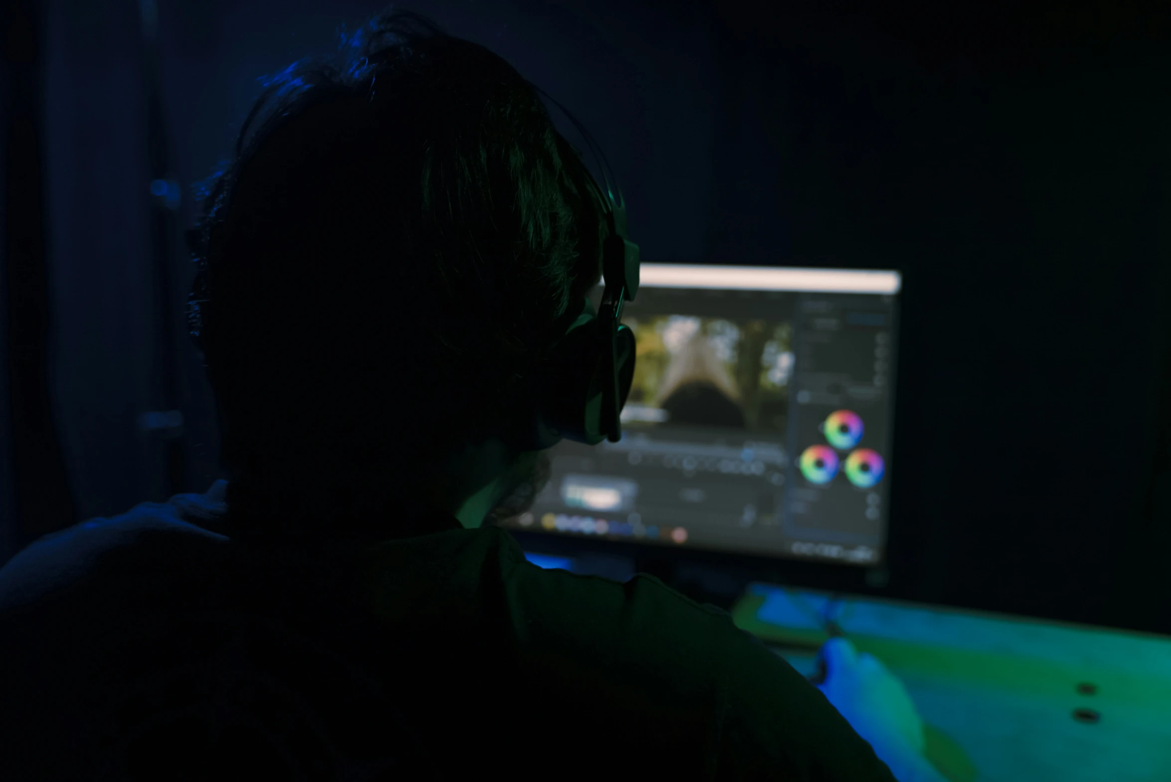 a man sitting in front of a computer screen