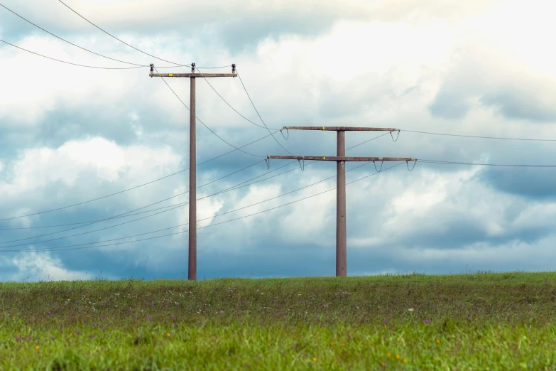 an electric pole and power lines against a sky