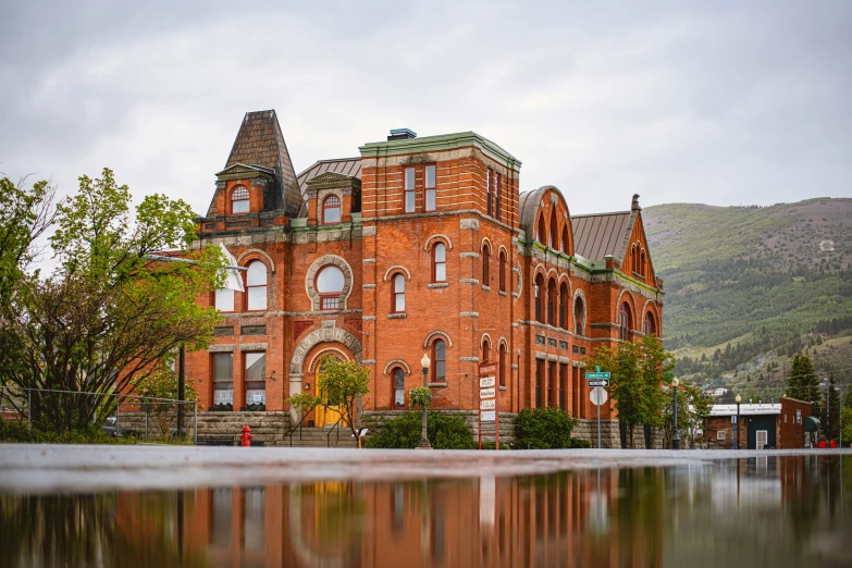 a large building sits at the foot of a mountain